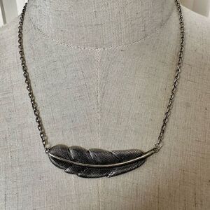 Silver tone feather pendant necklace
